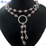 Load image into Gallery viewer, A silver necklace featuring pink rose quartz beads and a unique design