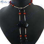 Load image into Gallery viewer, Black onyx and red agate lariat necklace displayed on a mannequin, showcasing the unique gemstone design.