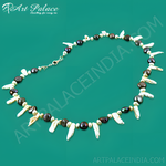 Load image into Gallery viewer, A unique pearl necklace featuring a variety of pearl shapes and colors, arranged on a green background.