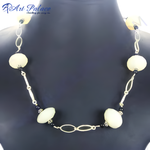 Load image into Gallery viewer, Cream-colored beaded statement necklace with silver accents displayed on a mannequin.