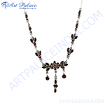 Load image into Gallery viewer, Sterling silver necklace with multiple red garnet stones in a floral pattern design.