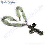 Load image into Gallery viewer, A beaded necklace with a silver cross pendant, green and blue beads