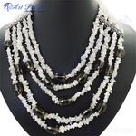 Load image into Gallery viewer, Multi-strand necklace featuring white gemstone chips and smoky quartz beads on a black mannequin