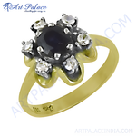 Load image into Gallery viewer, gold plating floral ring with a central dark blue sapphire surrounded by diamonds.