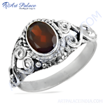 Load image into Gallery viewer, Sterling silver ring featuring an oval garnet gemstone set in a detailed, oxidized silver design.