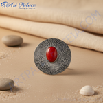 Load image into Gallery viewer, Silver stud earrings with a red oval gemstone center, featuring an intricate silver pattern.