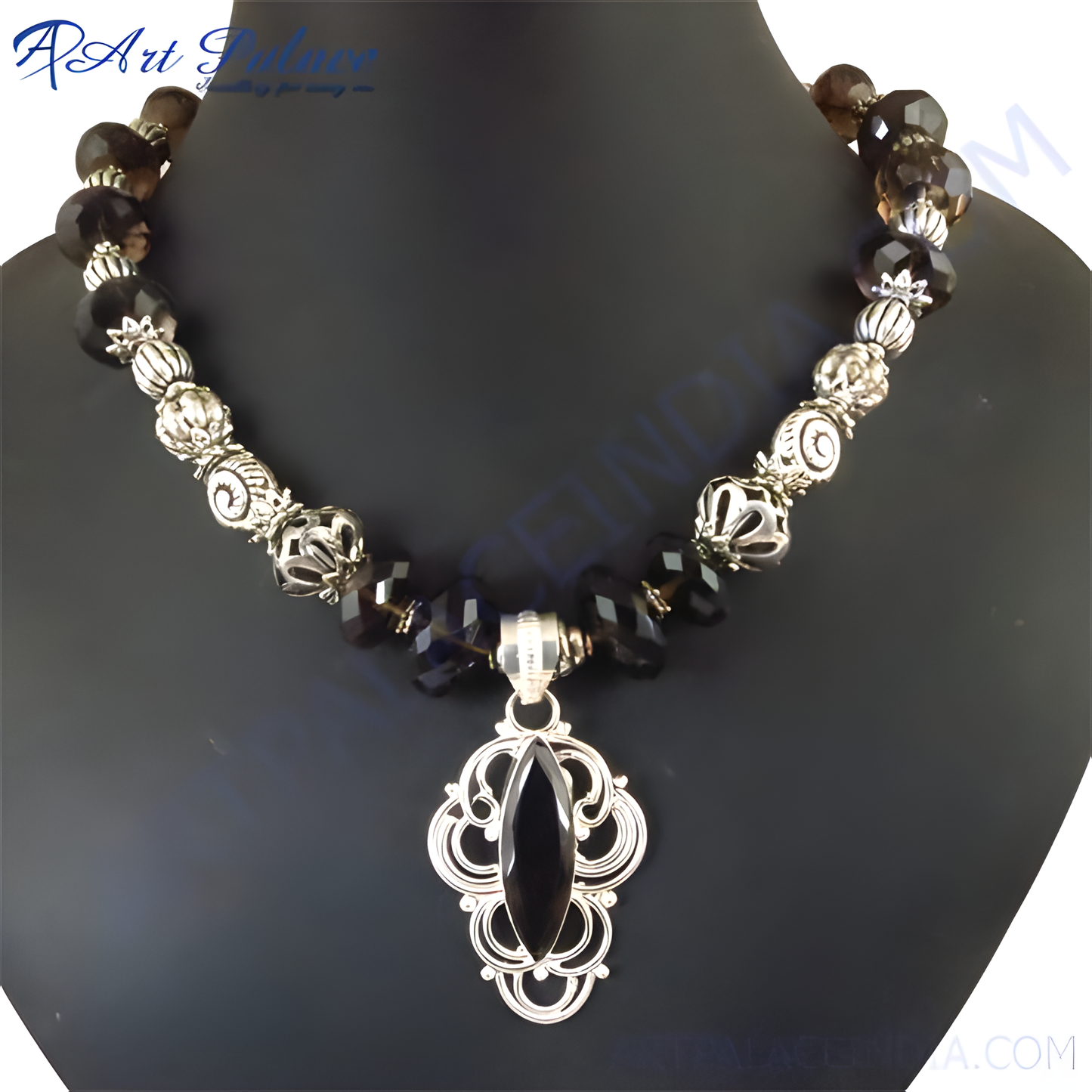 Elegant silver pendant necklace with a central black gemstone and smoky quartz beads on a black bust form.