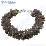 Load image into Gallery viewer, A close-up of a beaded gemstone bracelet with a silver clasp, featuring brown and purple beads.
