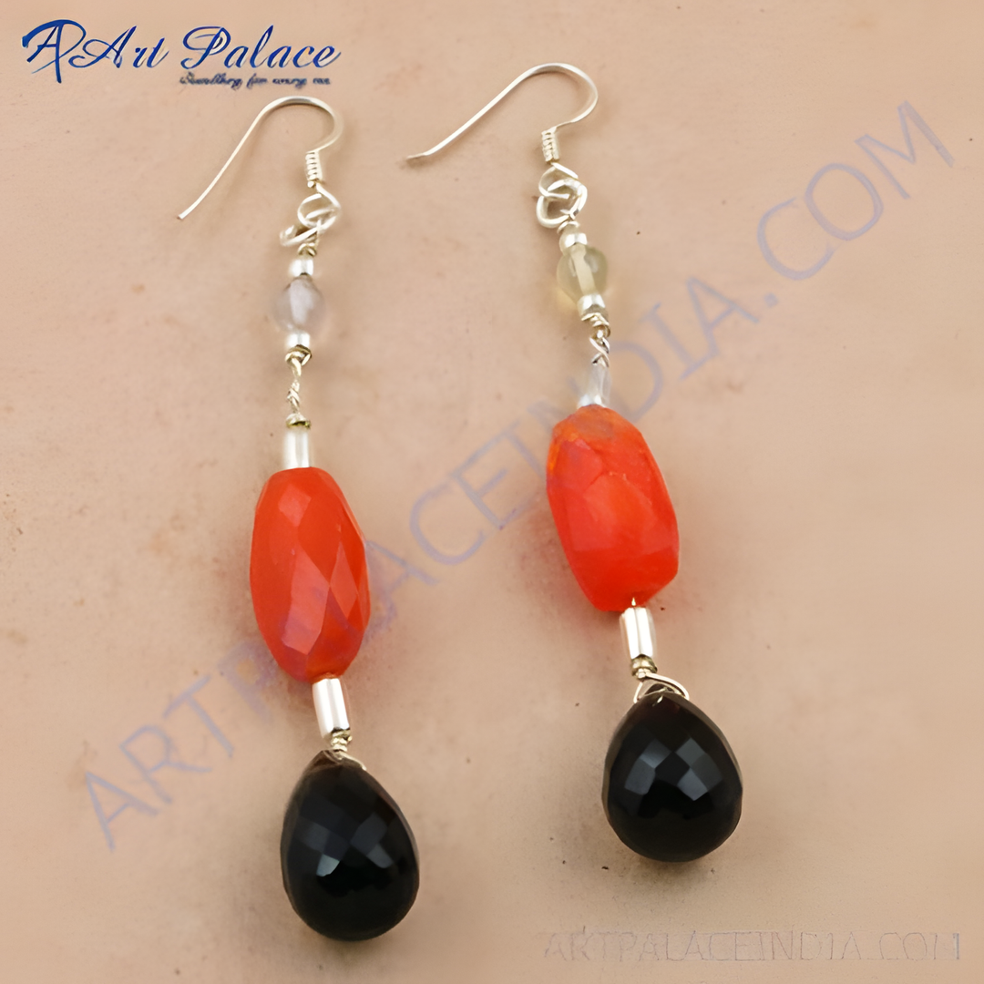 Silver dangle earrings featuring red and black gemstones, perfect for a stylish look.