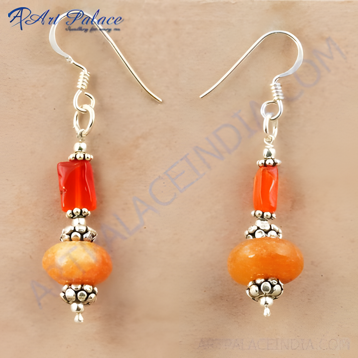 Sterling silver dangle earrings with orange gemstones, featuring a hook closure