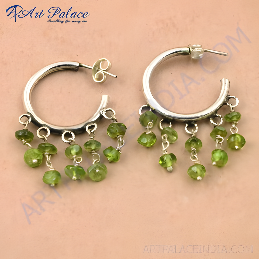 Sterling silver hoop earrings with dangling peridot gemstones in a vibrant green color.