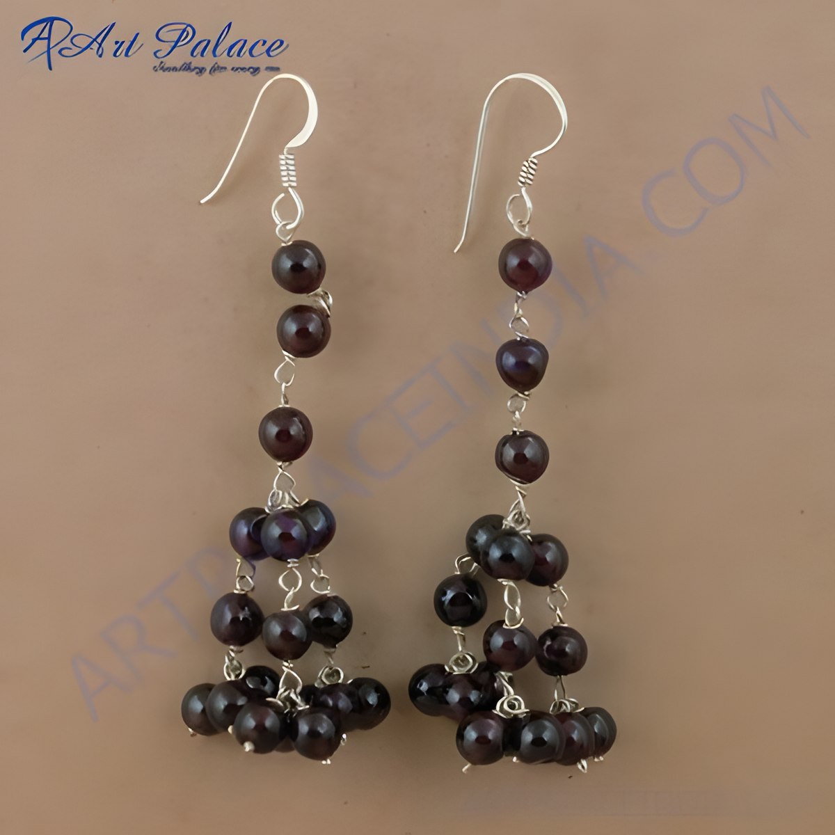Sterling silver drop earrings with cascading garnet beads and silver hooks, showcasing a classic and elegant design