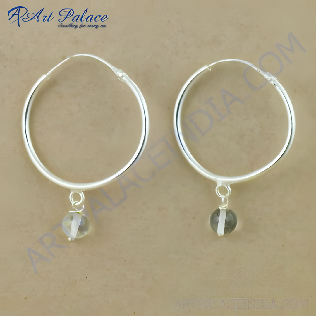 Sterling silver hoop earrings with gemstone dangle. Silver hoops featuring a round gemstone pendant.