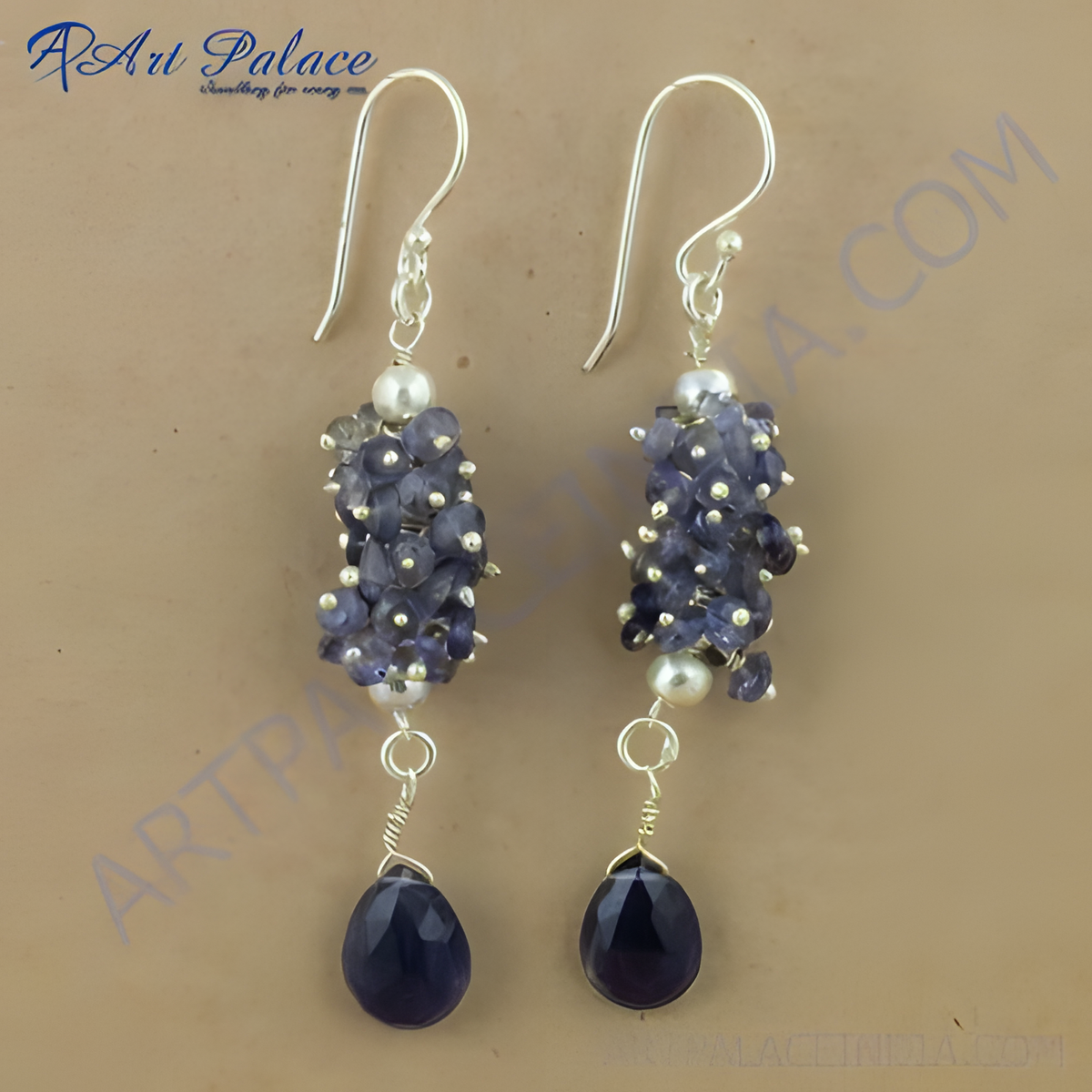 Sterling silver drop earrings featuring clusters of iolite gemstones and pear shaped drops in a deep blue hue