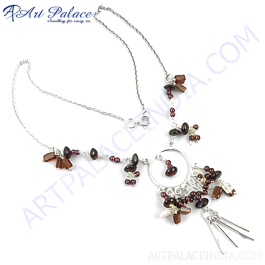Sterling silver statement necklace with garnet gemstones and intricate design.