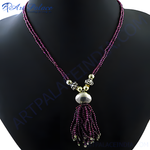 Load image into Gallery viewer, Ruby red gemstone beaded tassel necklace on a mannequin. Elegant, fashion jewelry.

