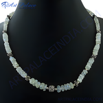 Load image into Gallery viewer, Moonstone bead necklace with silver accents displayed on a black background, a beautiful piece of gemstone jewelry
