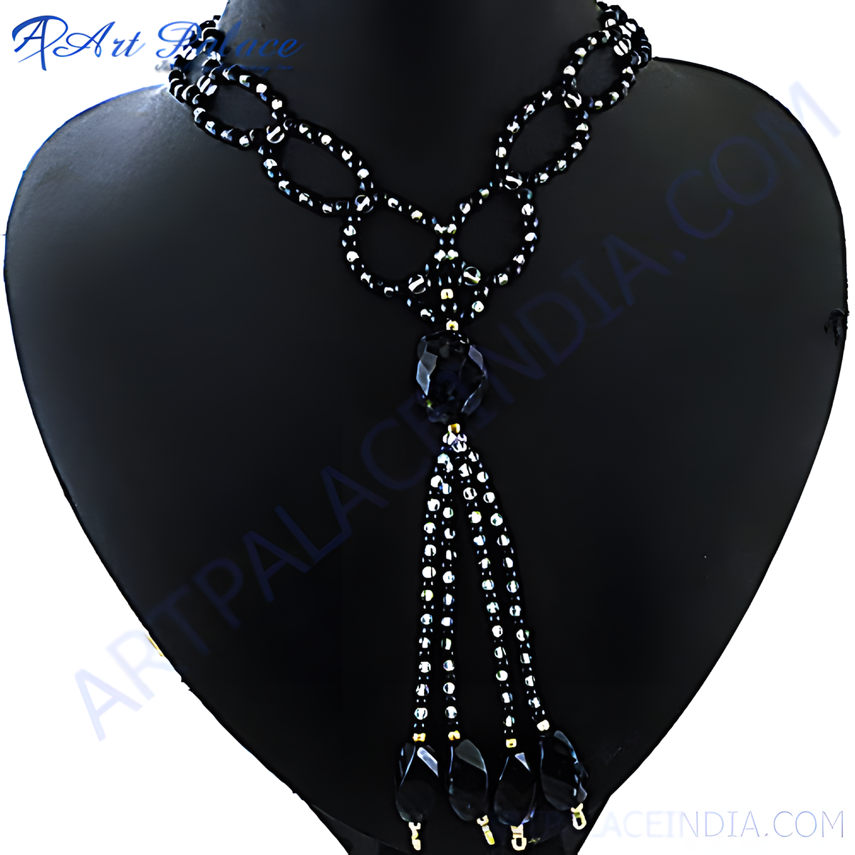 Black beaded statement necklace on a black jewelry display