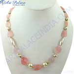 Load image into Gallery viewer, Pink rose quartz beaded necklace with gold accents, displayed on a mannequin, women&#39;s fashion jewelry.
