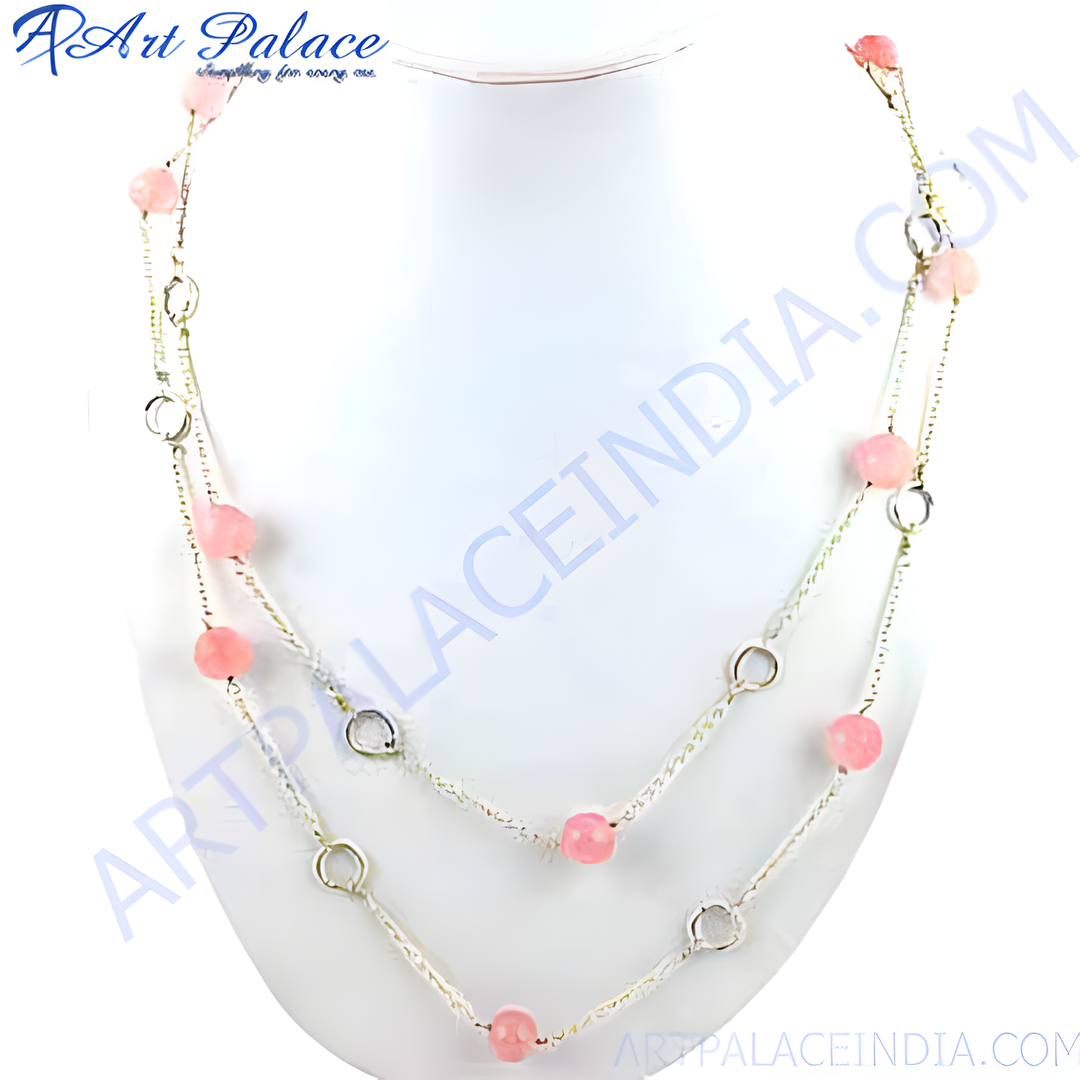 Delicate rose quartz bead necklace on a white mannequin. Featuring pink gemstone beads and silver chain.