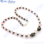 Load image into Gallery viewer, Rose quartz beaded necklace with sterling silver accents, featuring pink gemstone beads.
