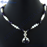 Load image into Gallery viewer, A pearl and amethyst pendant necklace displayed on a black background.
