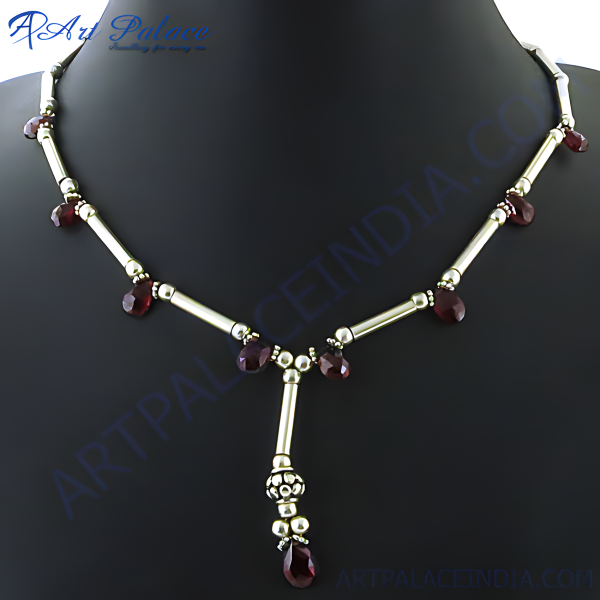 Sterling silver necklace with dark red garnet gemstones on a black mannequin