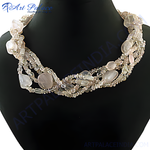 Load image into Gallery viewer, Multi-strand rose quartz beaded necklace with large oval and round beads on a black display.
