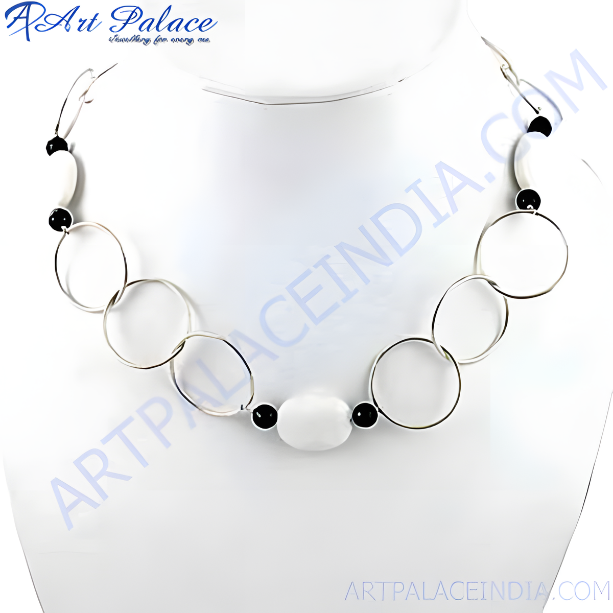 Silver geometric necklace featuring interconnected circles and white and black beads on a white background