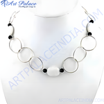 Load image into Gallery viewer, Silver geometric necklace featuring interconnected circles and white and black beads on a white background.
