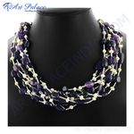 Load image into Gallery viewer, Multi-strand amethyst and pearl beaded necklace on a black mannequin, showing off a deep purple gemstone.
