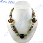 Load image into Gallery viewer, A colorful beaded statement necklace with various gemstones displayed on a white jewelry bust.
