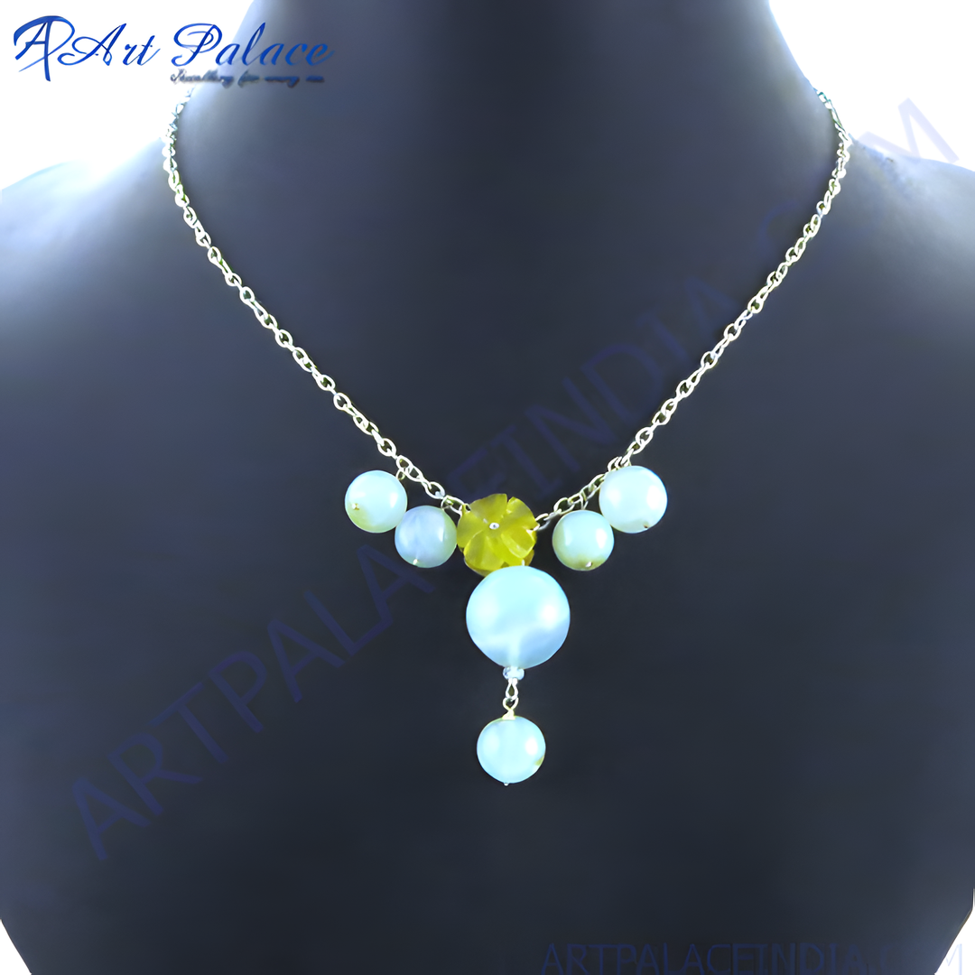 Silver chain necklace with light blue and yellow gemstones displayed on a mannequin
