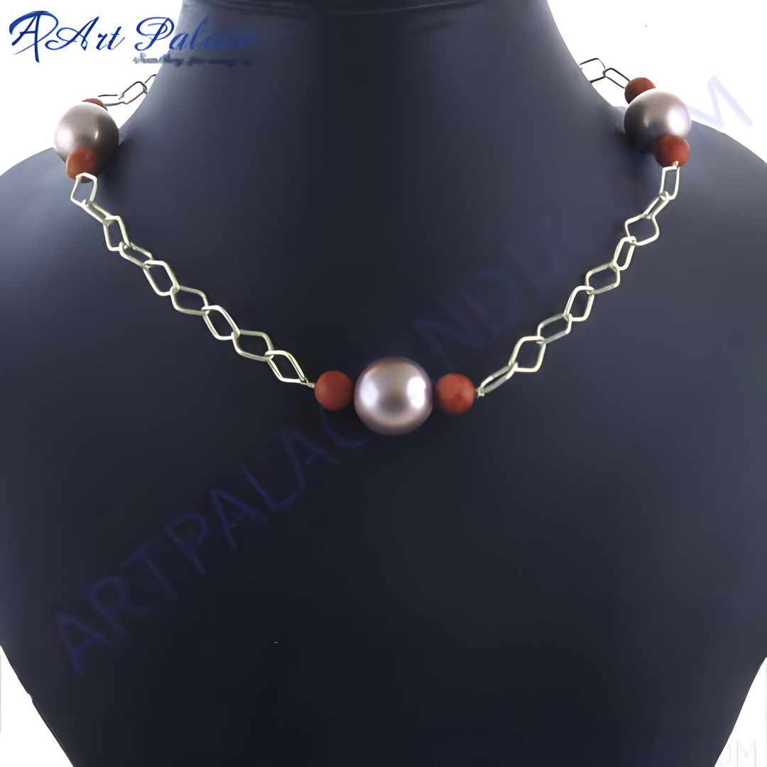 Pearl chain necklace with silver chain and brown beads on a black mannequin.