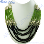 Load image into Gallery viewer, Multi-strand necklace featuring green and black beads on a white mannequin.
