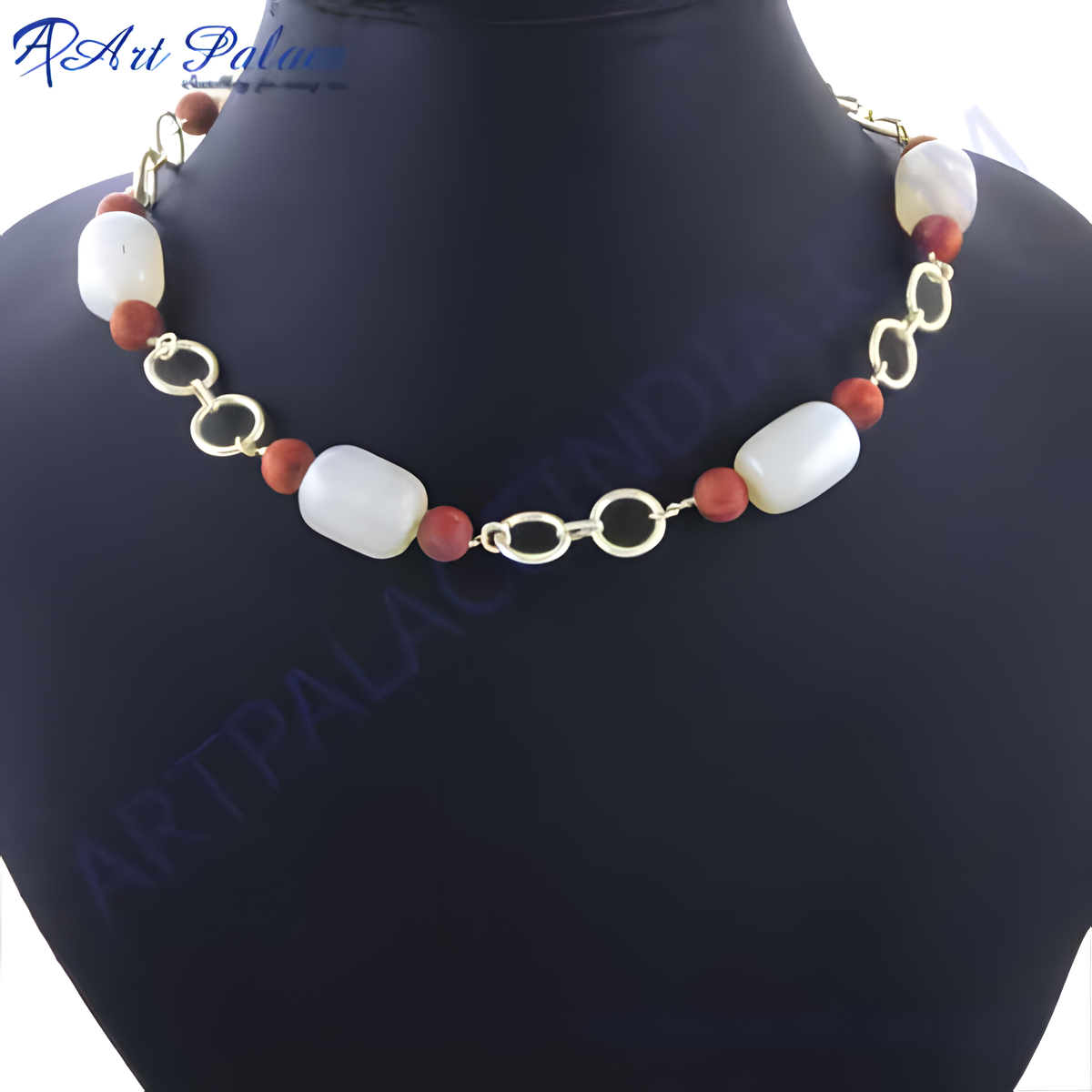 Beaded necklace featuring white beads and red beads connected by a gold chain, displayed on a black mannequin