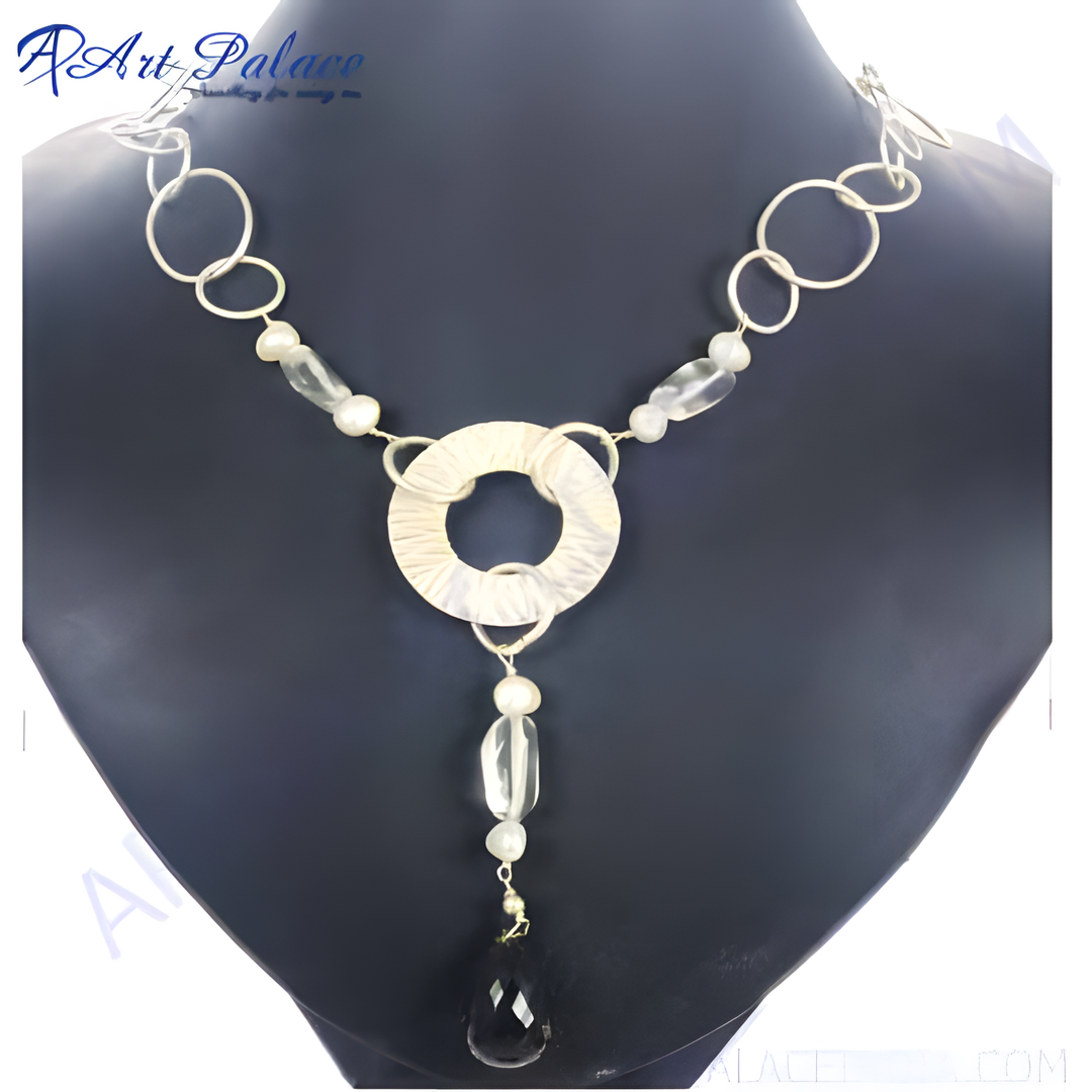 Silver statement necklace featuring a textured center ring and a black onyx teardrop pendant.