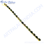 Load image into Gallery viewer, gold plating chain bracelet with oval green tourmaline gemstones set in gold plating.
