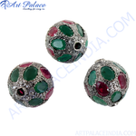 Load image into Gallery viewer, Close-up of a silver pendant with round ruby and emerald gemstones, set in a beaded style.

