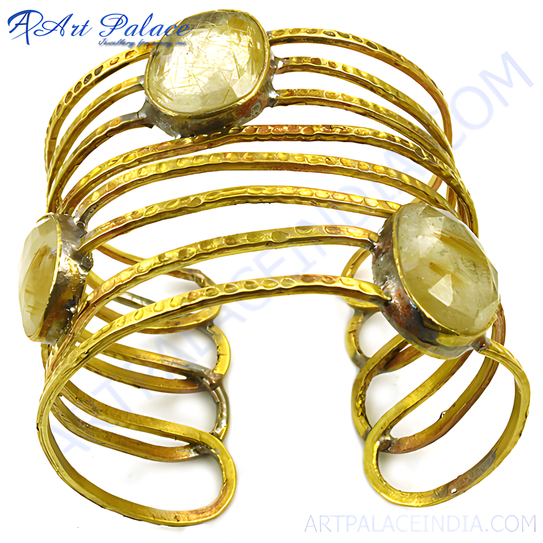 gold plating-toned metal cuff bracelet with rutilated quartz gemstones. A unique and elegant statement piece for women.