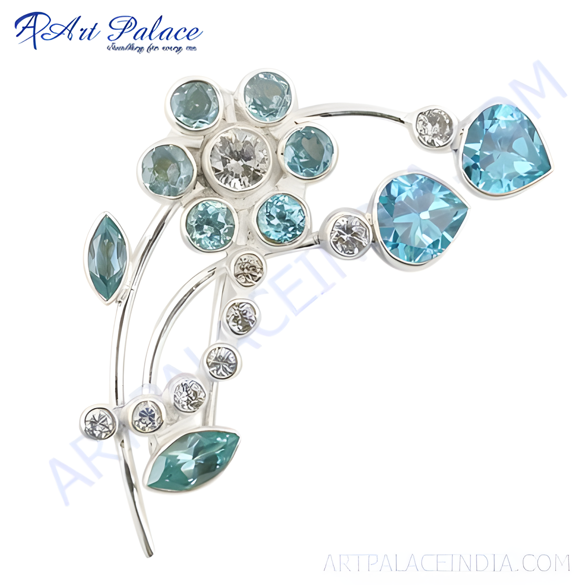 Silver floral brooch with various blue gemstones on white background