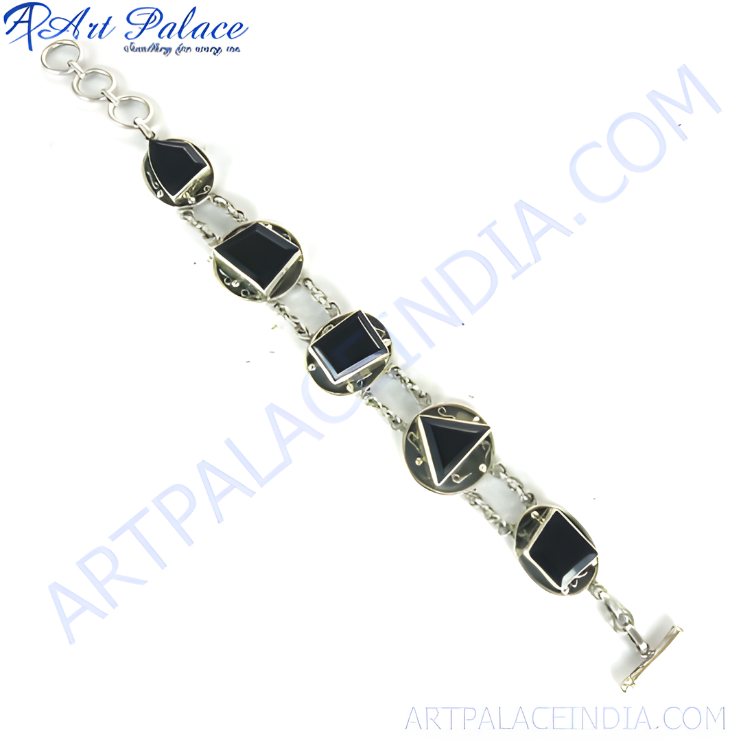 Sterling silver chain bracelet with various shaped black onyx stones, a toggle clasp, and a white background.