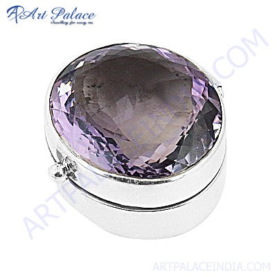 a large purple stone in a silver box
