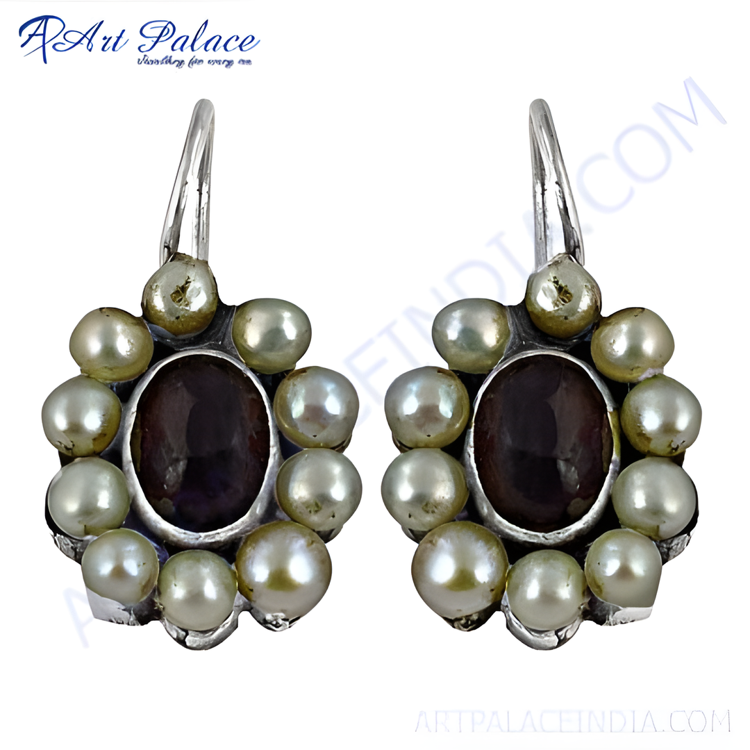 Sterling silver drop earrings with white pearls and a central dark gemstone design.