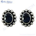 Load image into Gallery viewer, 925 sterling silver stud earrings featuring oval blue sapphire gemstones, surrounded by silver accents.
