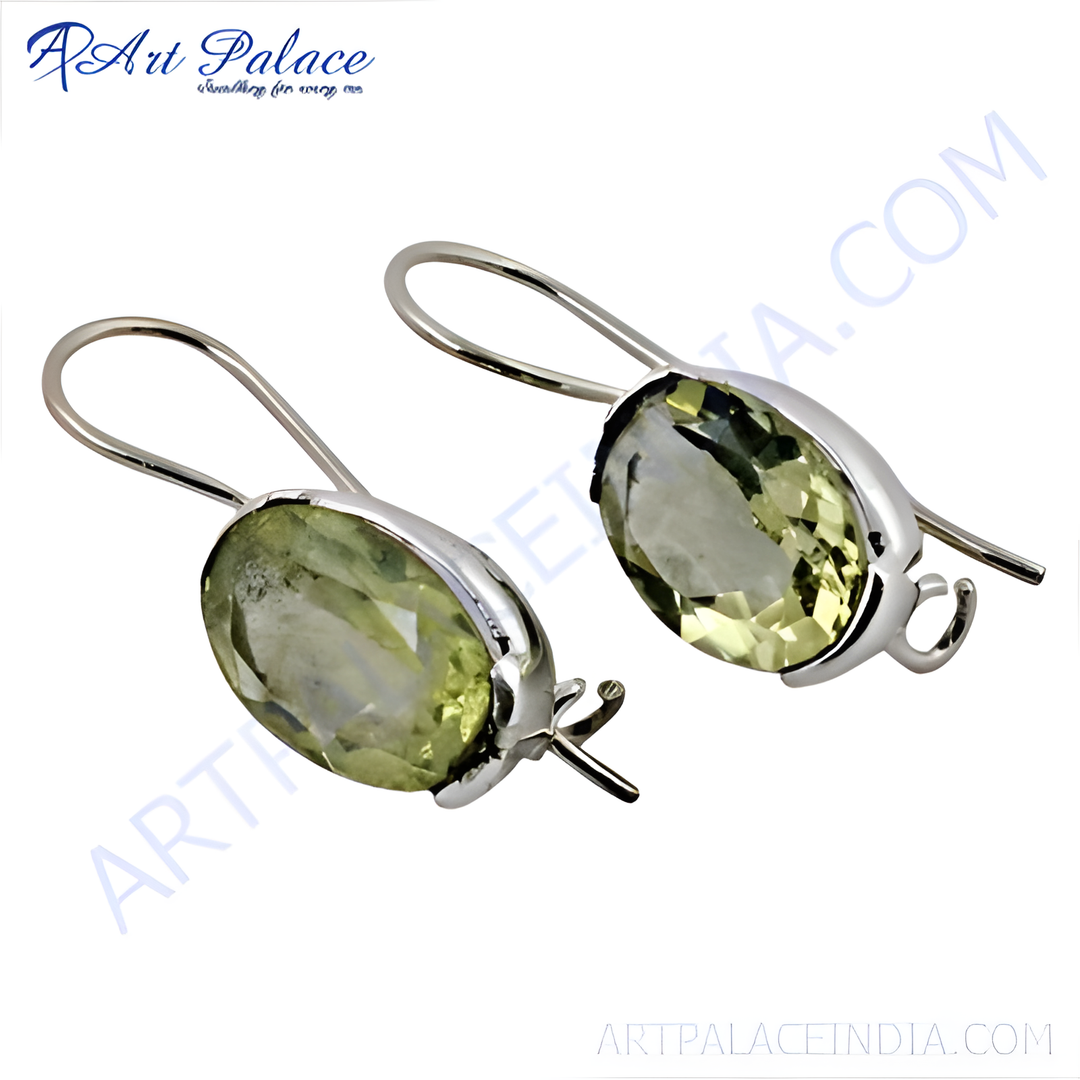 Sterling silver drop earrings featuring oval-cut lemon quartz gemstones, showcasing their yellow-green color and a delicate design.