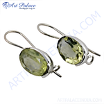 Load image into Gallery viewer, Sterling silver drop earrings featuring oval-cut lemon quartz gemstones, showcasing their yellow-green color and a delicate design.
