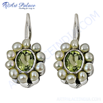 Load image into Gallery viewer, Sterling silver drop earrings with white pearls surrounding a green peridot gemstone center
