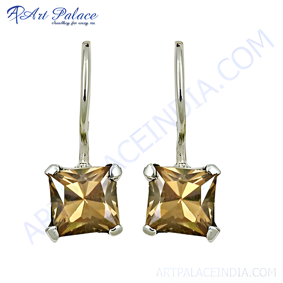 Silver drop earrings featuring princess-cut topaz gemstones. The topaz stones are a warm brown color.
