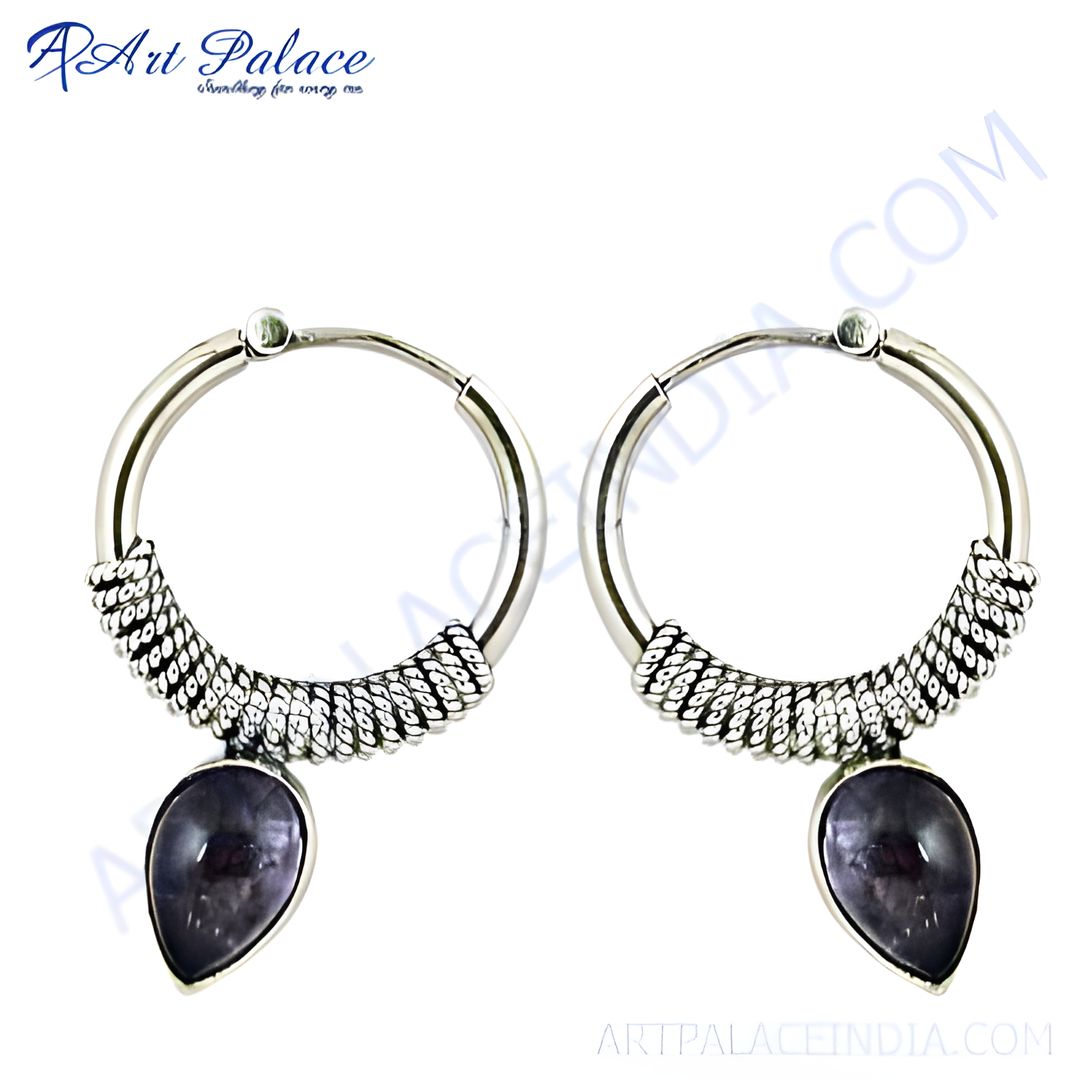 Sterling silver hoop earrings with a detailed design and teardrop-shaped amethyst gemstone.